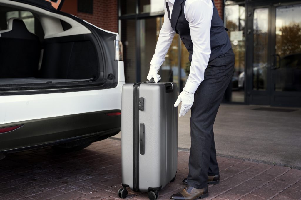 side view valet holding baggage