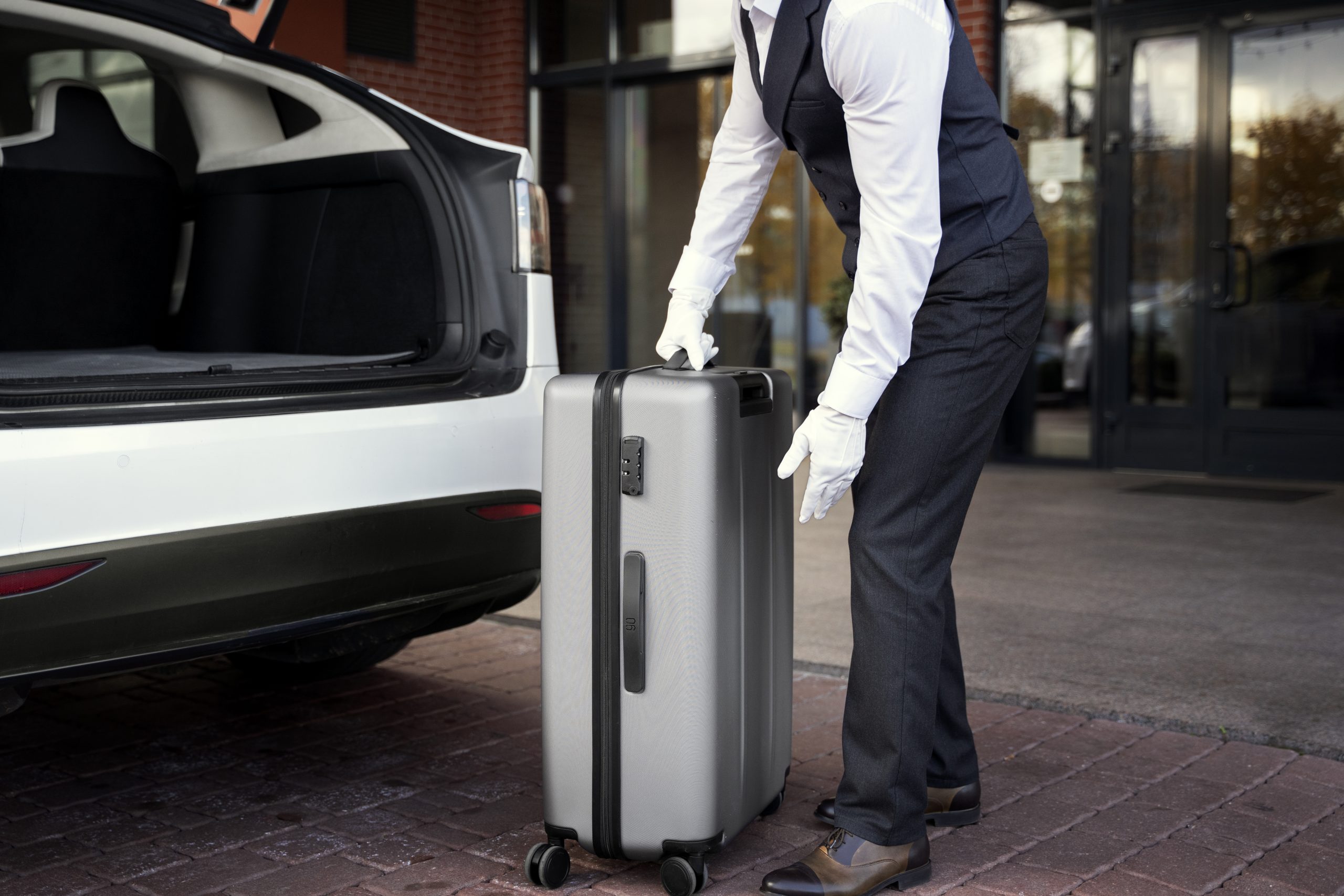 side view valet holding baggage